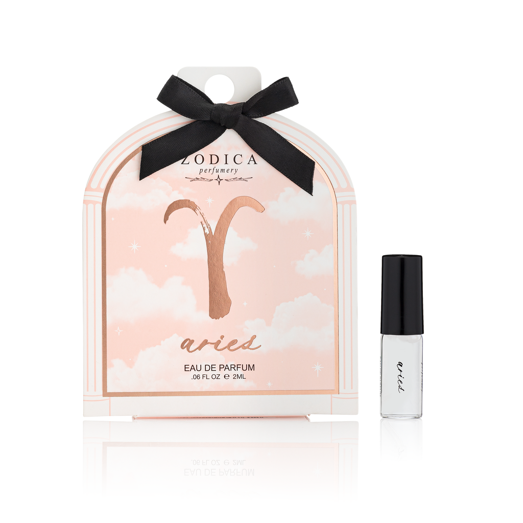 Aries zodiac perfume packaging with a black bow and a small bottle of perfume on a white background.
