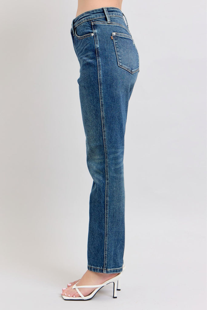Blue jeans worn by a person on a white background