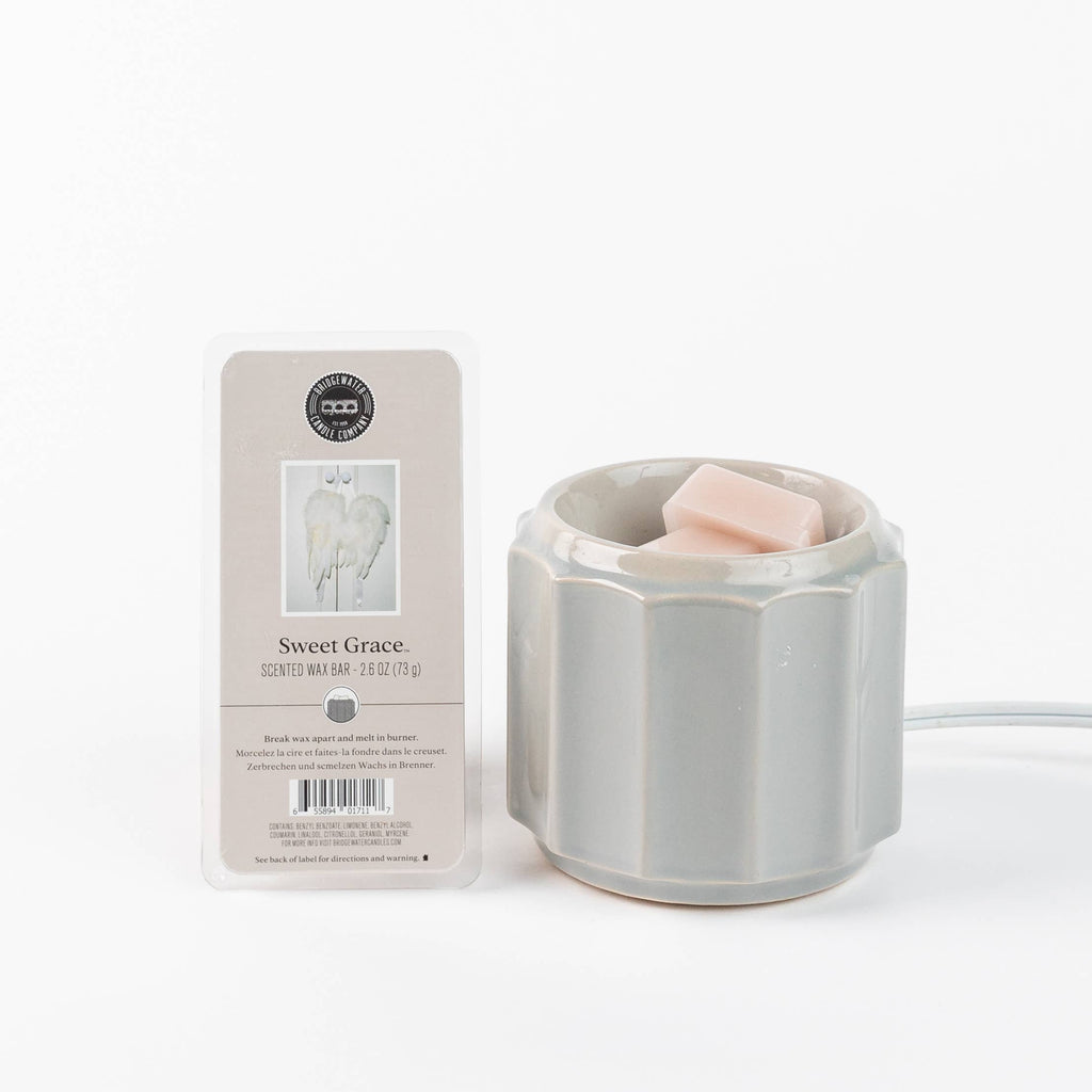 Gray wax warmer with packaging labeled 'Sweet Grace' on a white background