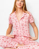 Red and white candy cane print short sleeve button-up pajama top with matching pants, soft knit holiday sleep set by The Royal Standard.