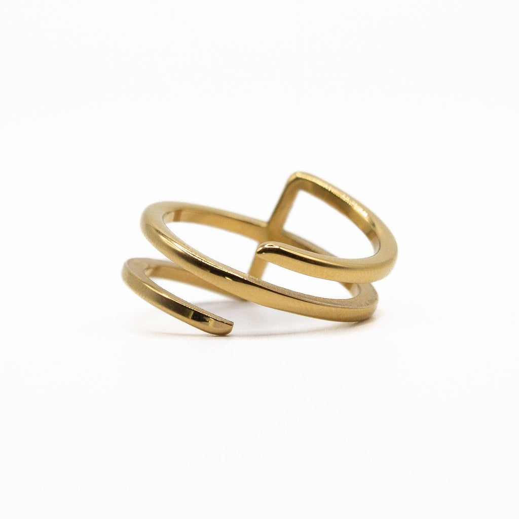 Gold ring with a modern design on a white background