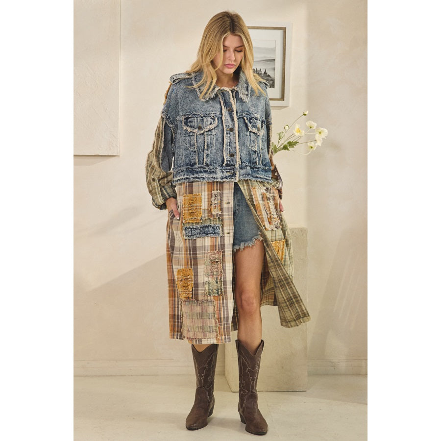 Woman wearing a denim jacket, plaid dress, and brown boots in a room with a neutral color scheme.