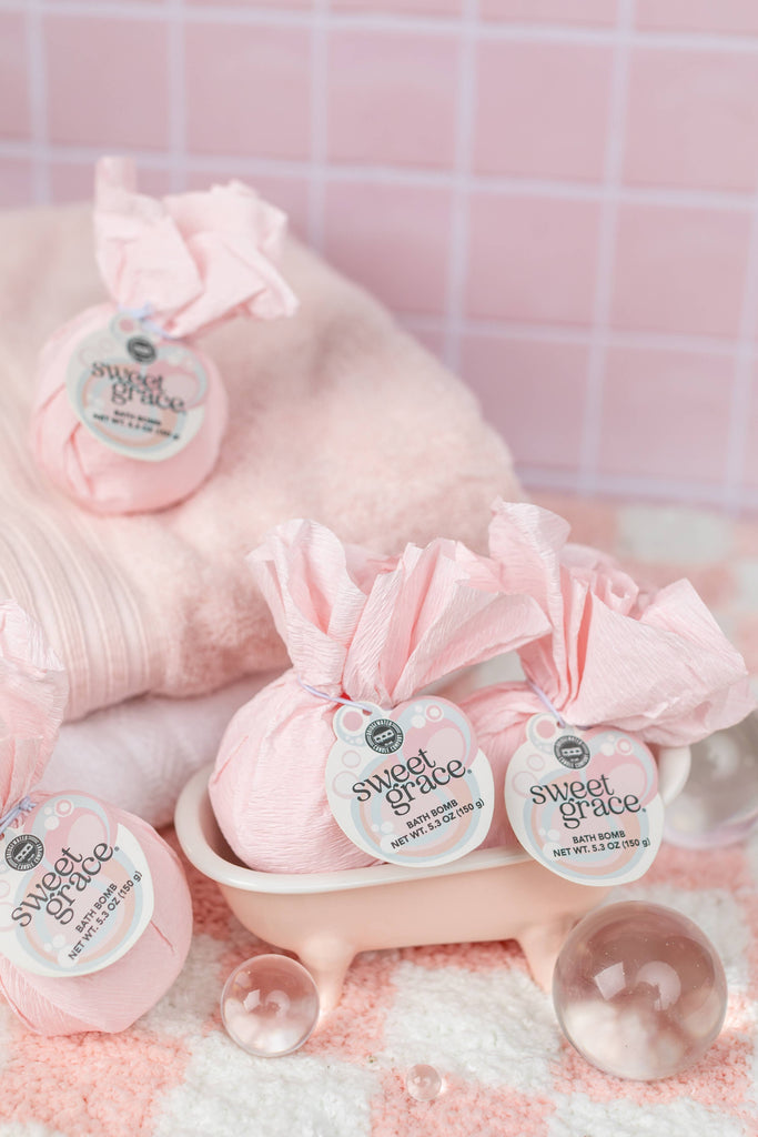 Pink bath bombs with 'sweet grace' label on a pink checkered background
