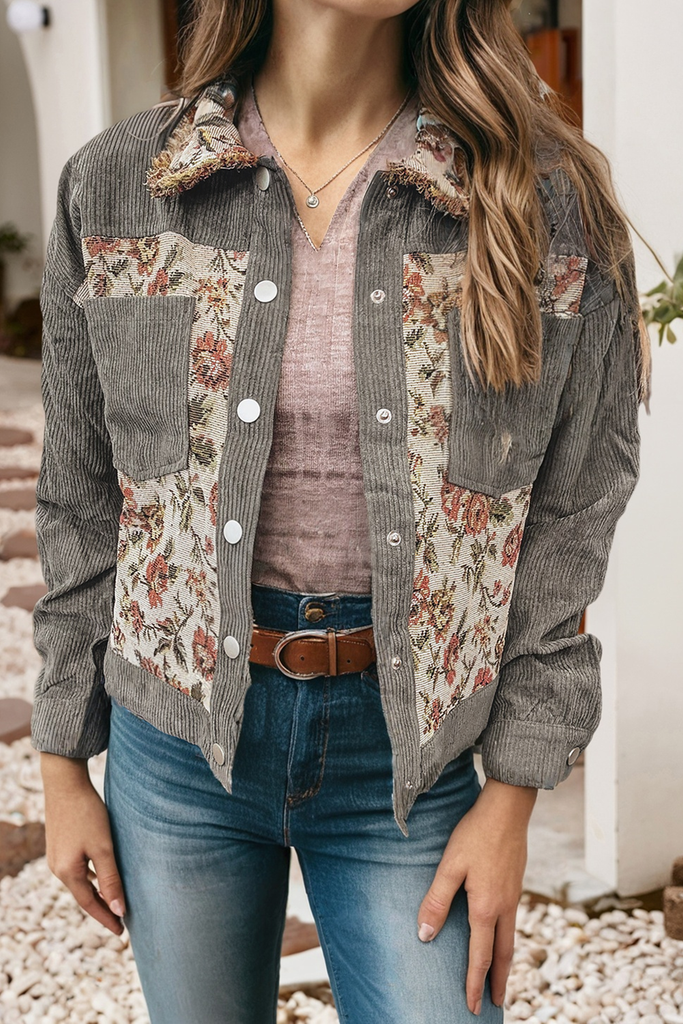 Person wearing a floral and denim patterned shirt with a neutral background