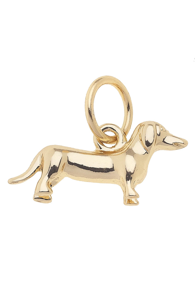 Gold dachshund dog charm on a white background