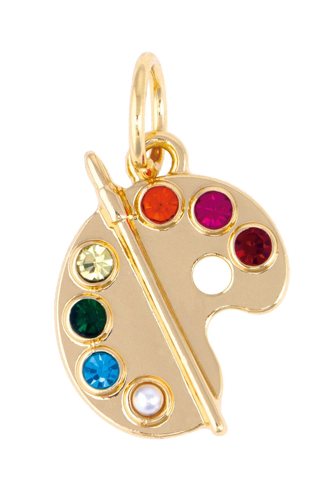Gold pendant shaped like a paint palette with colorful gemstones on a white background