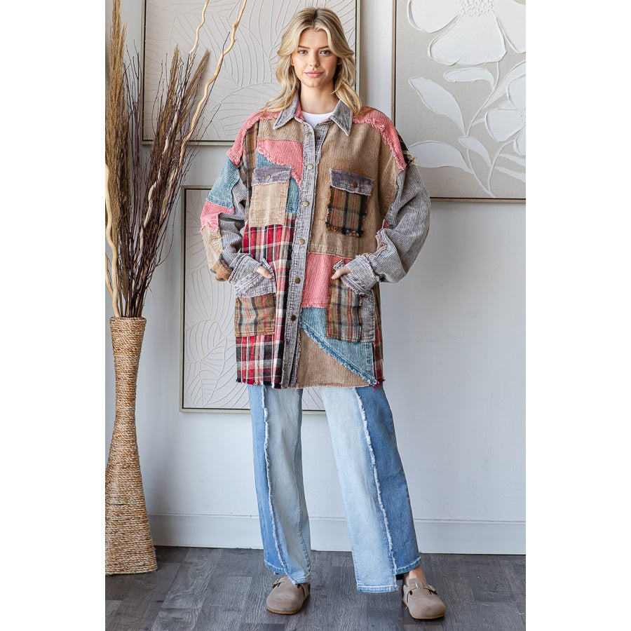Woman wearing a patchwork jacket and jeans standing in a room with decorative elements.
