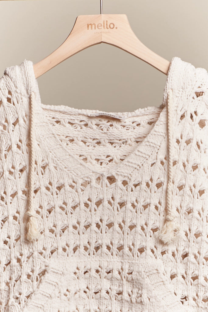Beige crochet top on a hanger with 'mello.' branding.