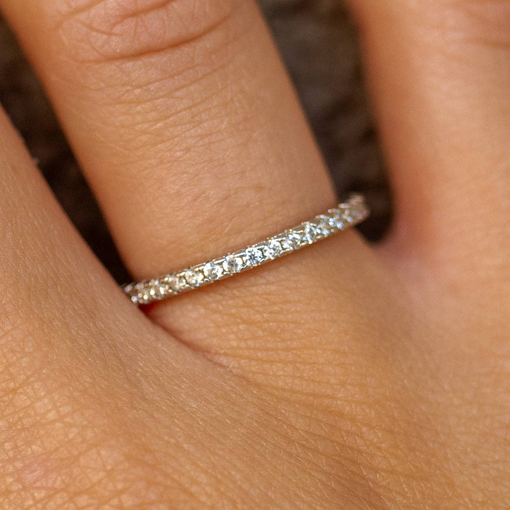 A gold-plated, sterling silver ring with cubic zirconia embellishments, worn on a person's finger.