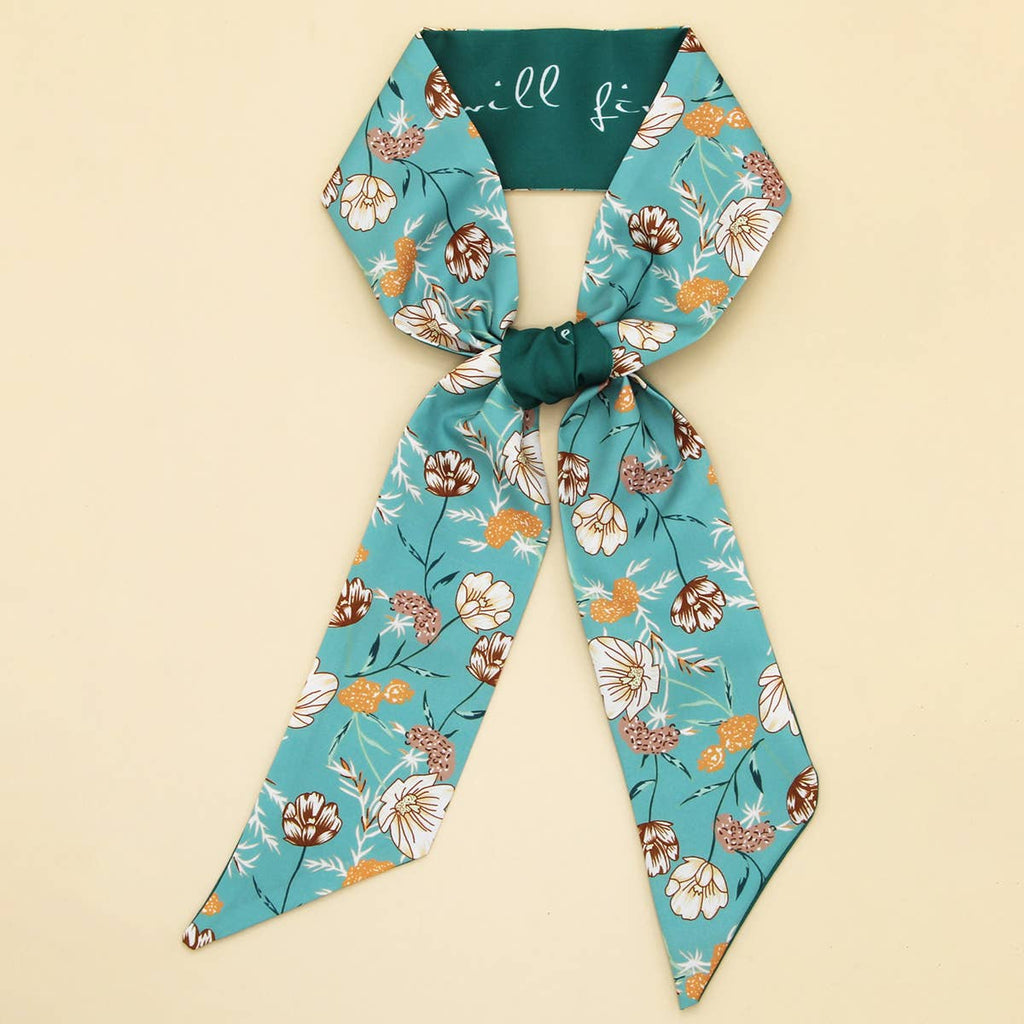 Floral headband with teal ribbon on a beige background