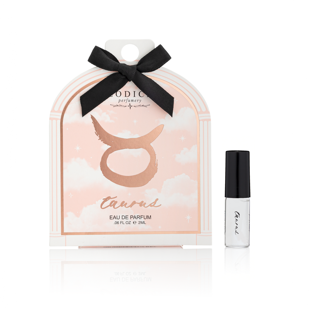 Taurus zodiac sign perfume packaging with a black bow and a small perfume bottle on a white background.