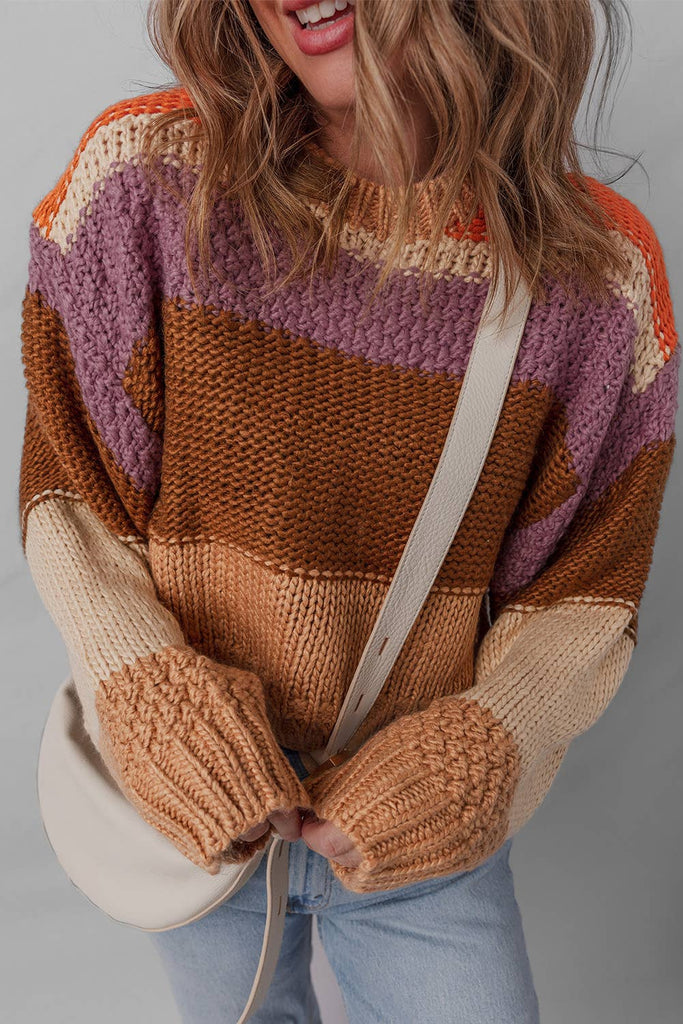 Person wearing a colorful striped sweater with a neutral background