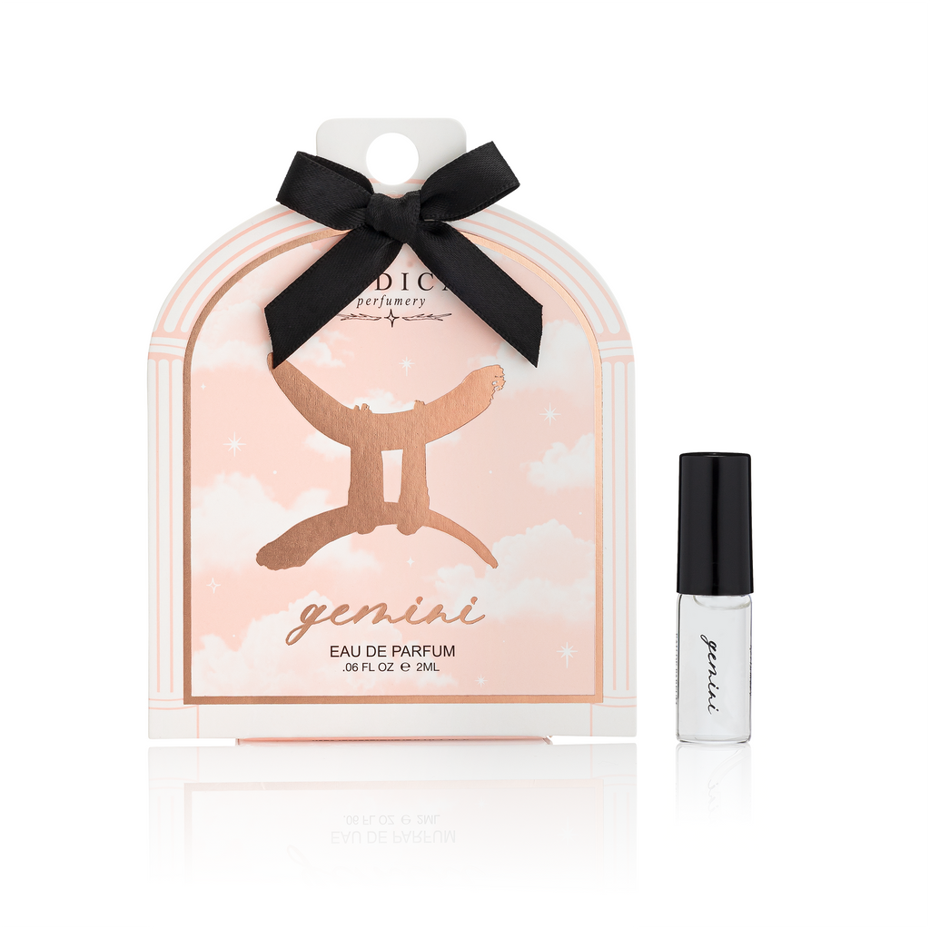 Perfume packaging with a black bow and a small bottle on a white background