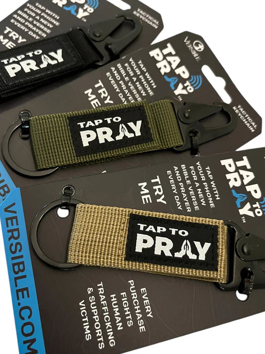 Keychains with 'Tap to Pray' label on packaging