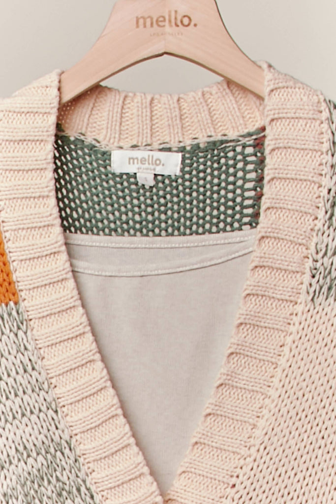 Knitted cardigan with a visible brand label on a hanger
