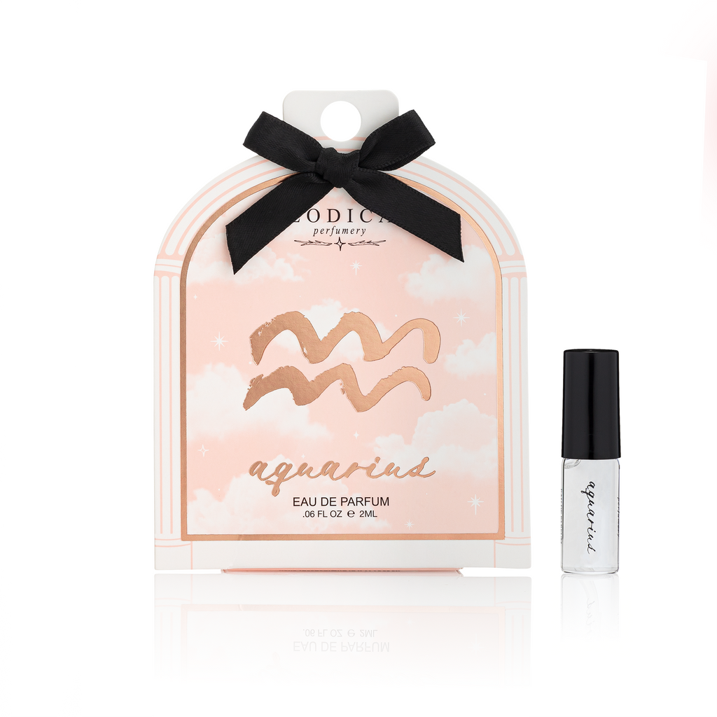 Aquarius eau de parfum packaging with a black bow and small bottle on a white background