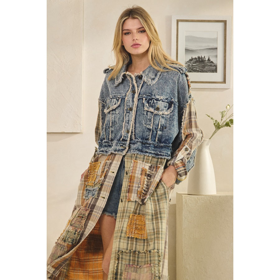Woman wearing a denim jacket over a plaid dress in a room with a painting on the wall.