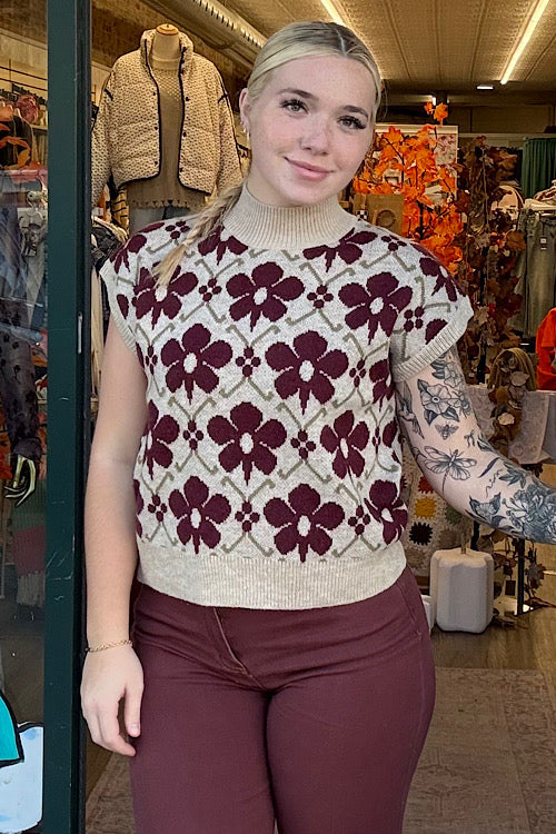 Woman wearing a patterned sweater in a store setting