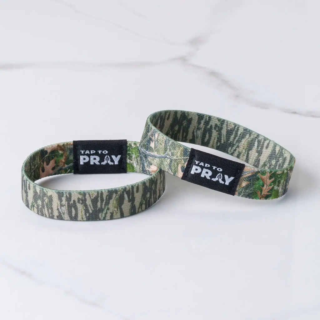 Two camouflage-patterned wristbands with 'Tap to Pray' labels on a white background