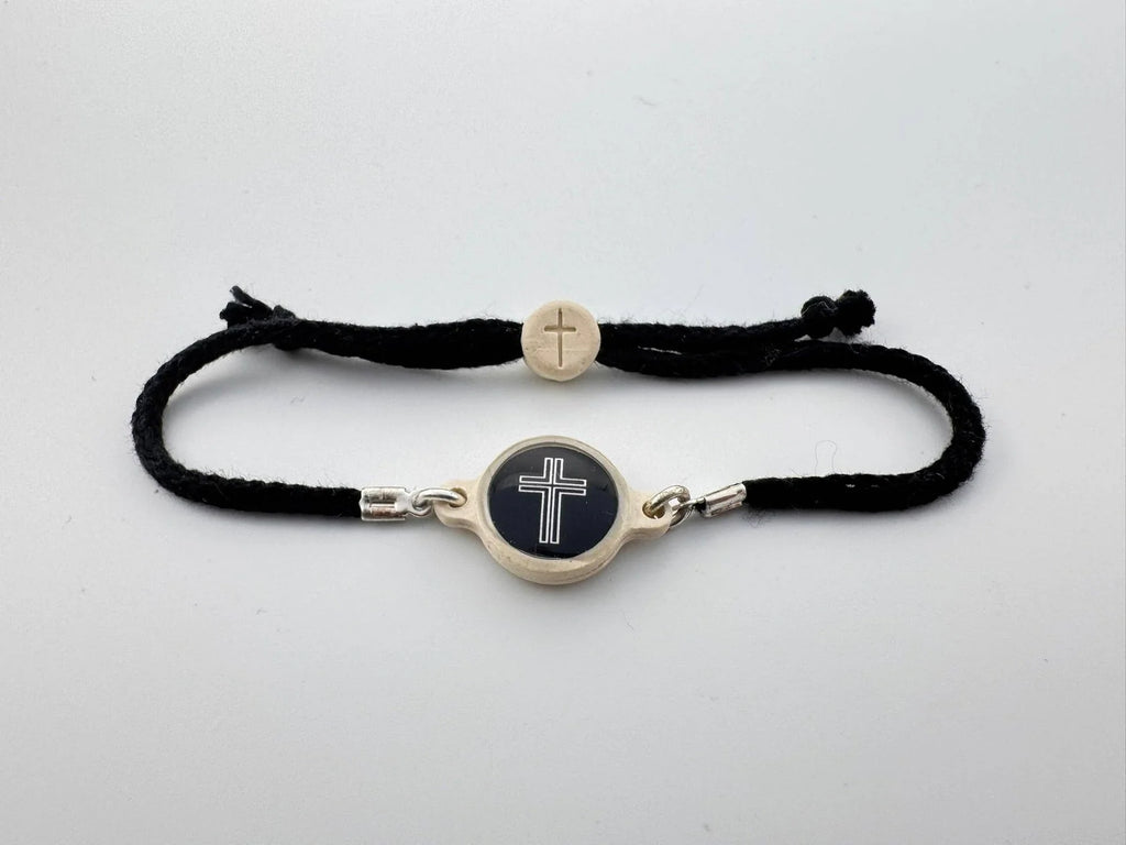 Bracelet with cross charm on a white background
