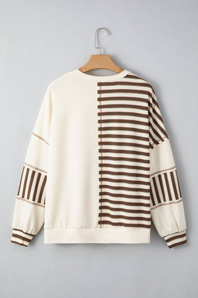 Sweater with brown and white striped pattern on a gray background