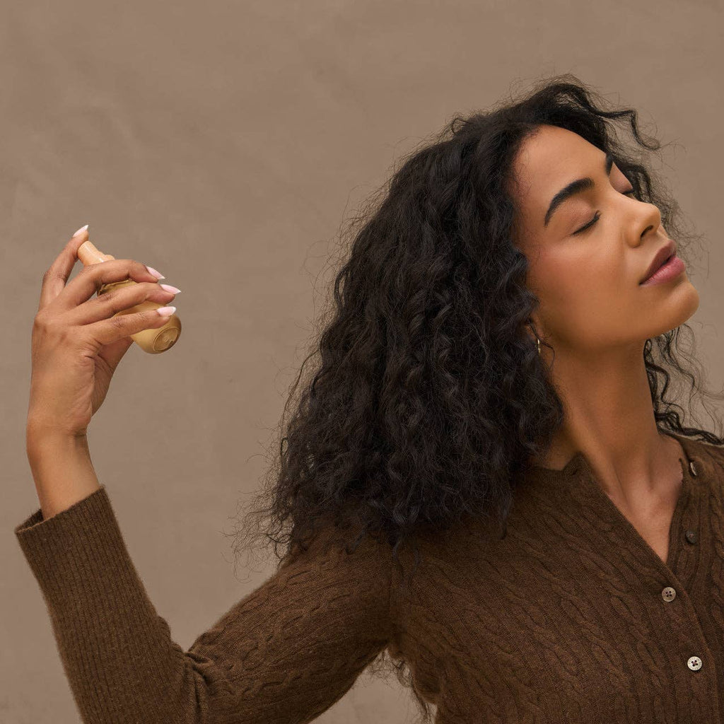 Woman holding a banana against a brown background