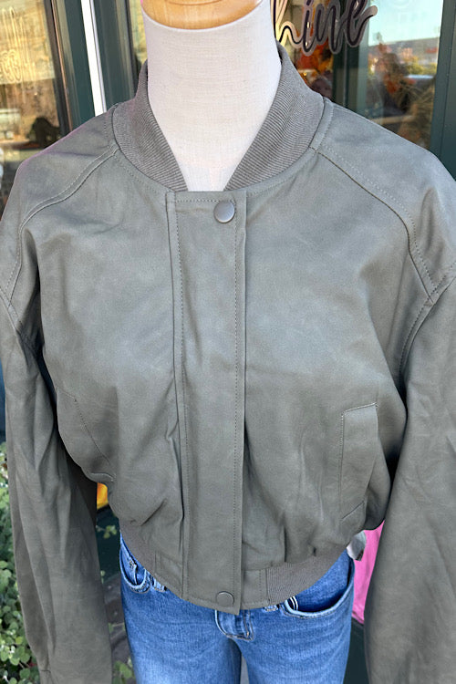 Green  jacket on a mannequin with a blurred background