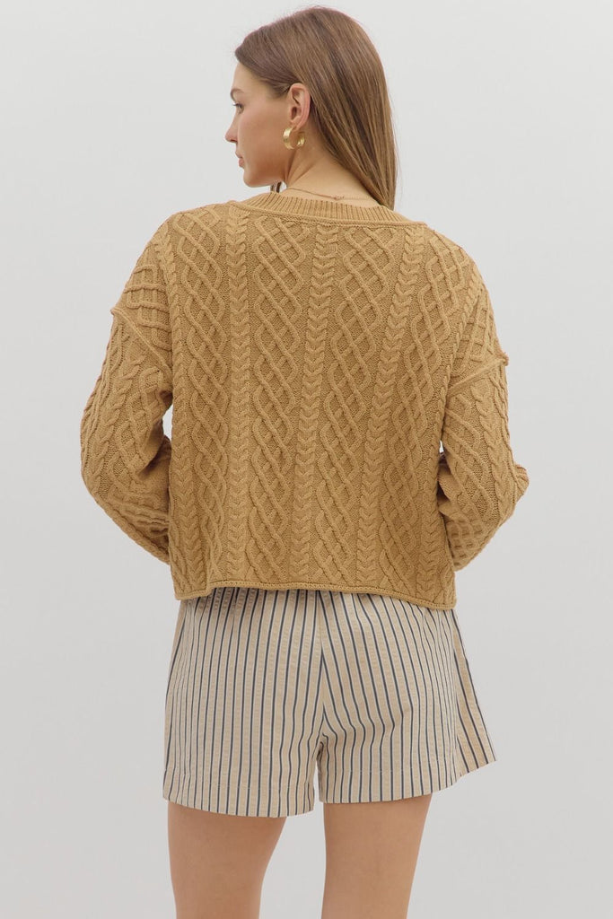 Camel cropped cable knit cardigan with long sleeves, V-neckline, front pockets, and relaxed fit