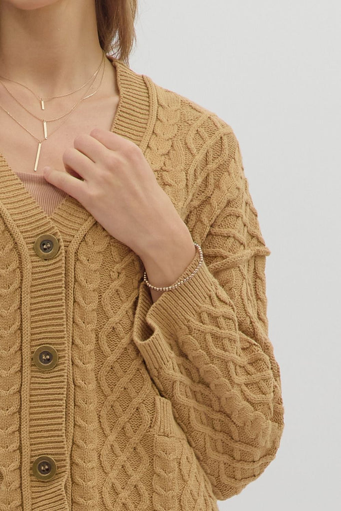 Camel cropped cable knit cardigan with long sleeves, V-neckline, front pockets, and relaxed fit