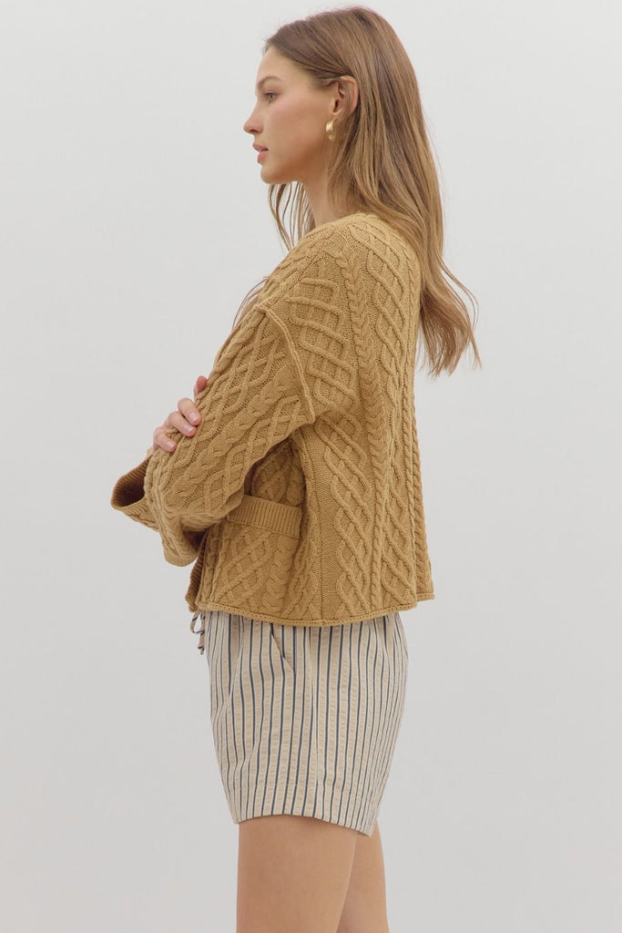 Camel cropped cable knit cardigan with long sleeves, V-neckline, front pockets, and relaxed fit