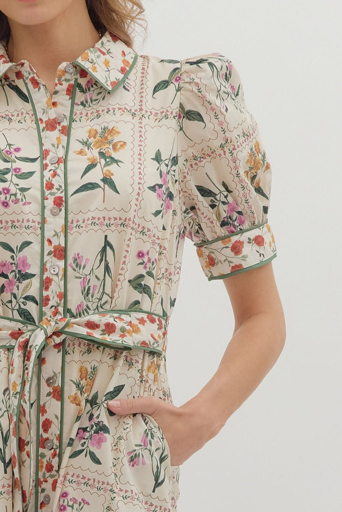 Floral print midi dress with short puff sleeves, button front closure, contrast binding, removable belt, and side pockets