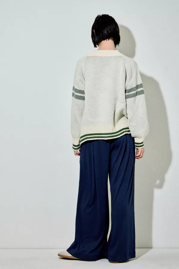 Araminta cream and green 'Ski' raglan sweater, with green text and stripes, a relaxed fit, and a ribbed crewneck.