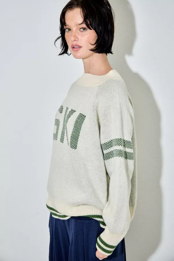 Araminta cream and green 'Ski' raglan sweater, with green text and stripes, a relaxed fit, and a ribbed crewneck.