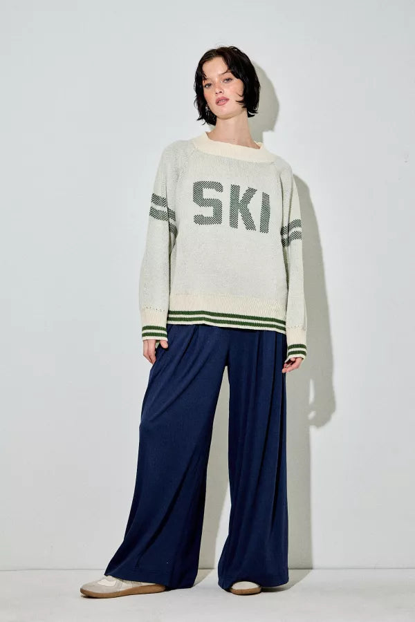 Araminta cream and green 'Ski' raglan sweater, with green text and stripes, a relaxed fit, and a ribbed crewneck.