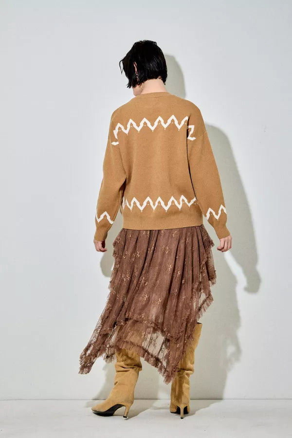 A camel-colored crewneck sweater with a large white graphic of three running horses on the front and white zigzag patterns above and below the main graphic.