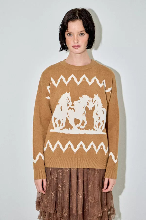 A camel-colored crewneck sweater with a large white graphic of three running horses on the front and white zigzag patterns above and below the main graphic.