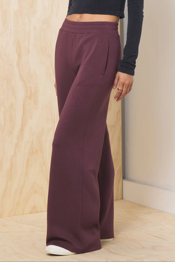 "Vintage Havana Truffle Cloud Fleece Flare Pants in merlot featuring a soft cloud fleece fabric, relaxed fit, and flattering flared leg silhouette for cozy yet elevated everyday wear."