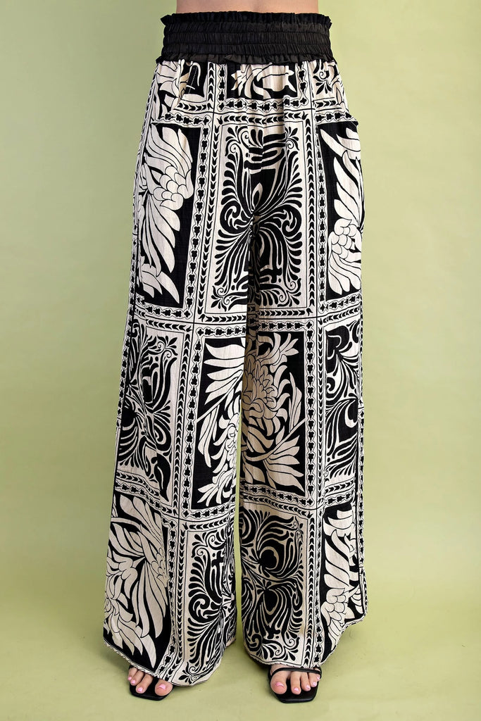 Black and white patterned pants on a green background