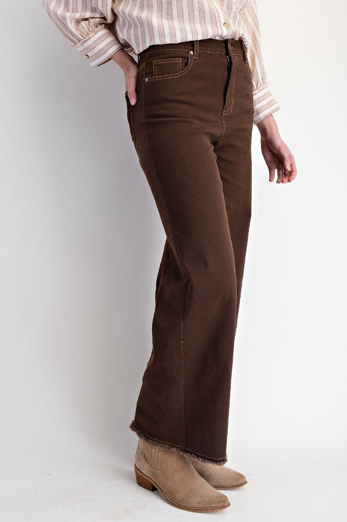 Coffee brown high-waisted straight-leg washed twill pants with raw frayed hem, five-pocket design, and button-zip fly