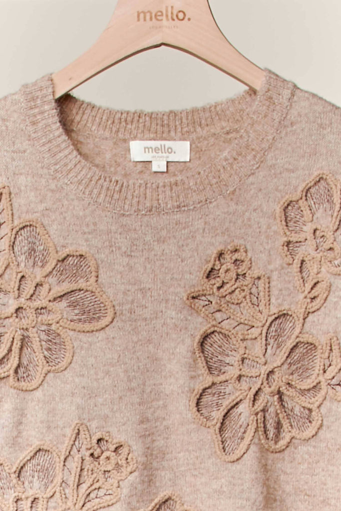 Taupe knit sweater with tonal embroidered floral designs and relaxed fit.