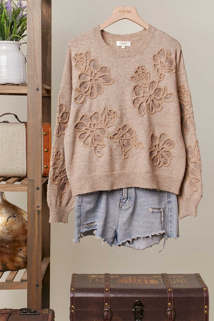 Taupe knit sweater with tonal embroidered floral designs and relaxed fit.
