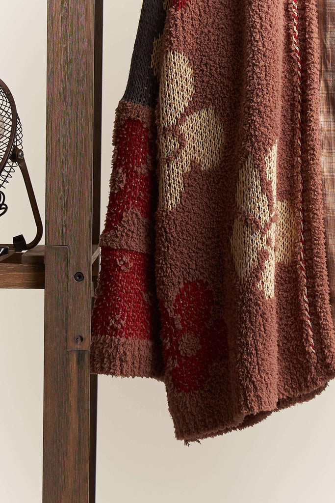 Oversized terry knit cardigan in brown with multicolor floral and stripe patterns.