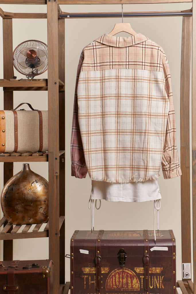 Oversized multi-plaid shacket in beige, cream, and blush with raw-edge hem and chest pocket.