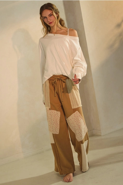 Breathe effortless charm into your everyday with the Cobi wide-leg pants. This artful piece combines cozy comfort with bohemian flair, featuring textural knit insets and floral paneling for a uniquely laid-back look. The slouchy silhouette and adjustable drawstring waist make them a dream to wear—from weekend lounging to casual brunch outings.