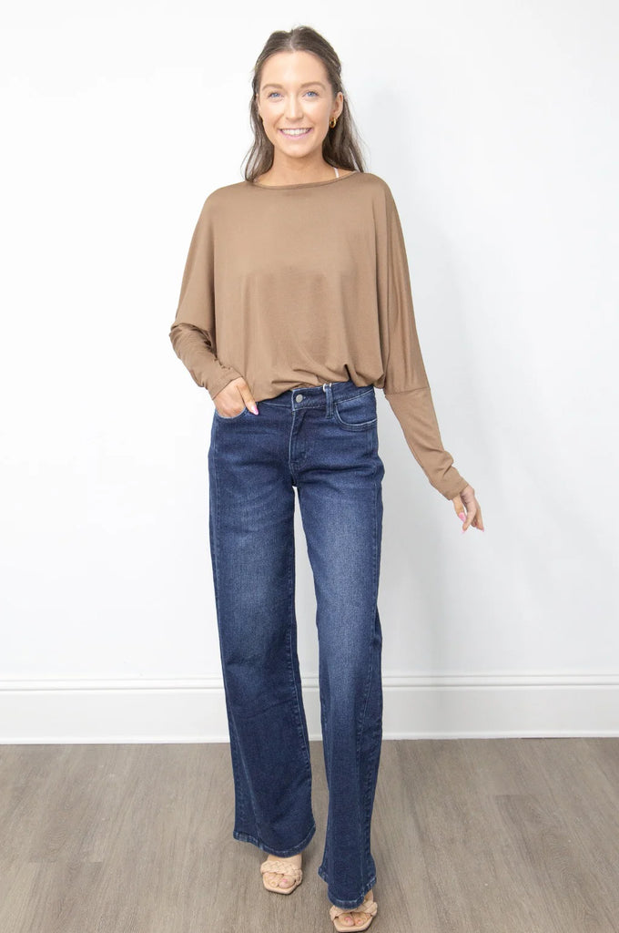 A high-waisted, wide-leg pair of dark wash jeans with a frayed hem.