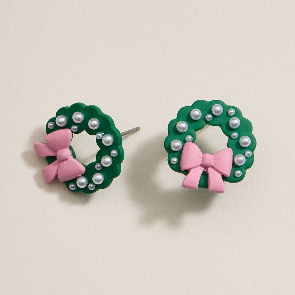 Green enamel Christmas wreath stud earrings with pearl accents and pink bows.