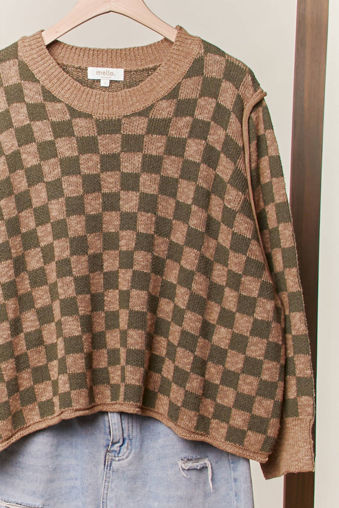 Olive and taupe checker-pattern knit sweater with relaxed fit and ribbed trim.