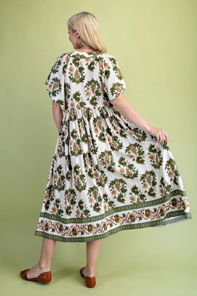 Midi dress with olive and golden floral print, V-neckline, scalloped short sleeves, covered buttons, and flowing skirt with border trim
