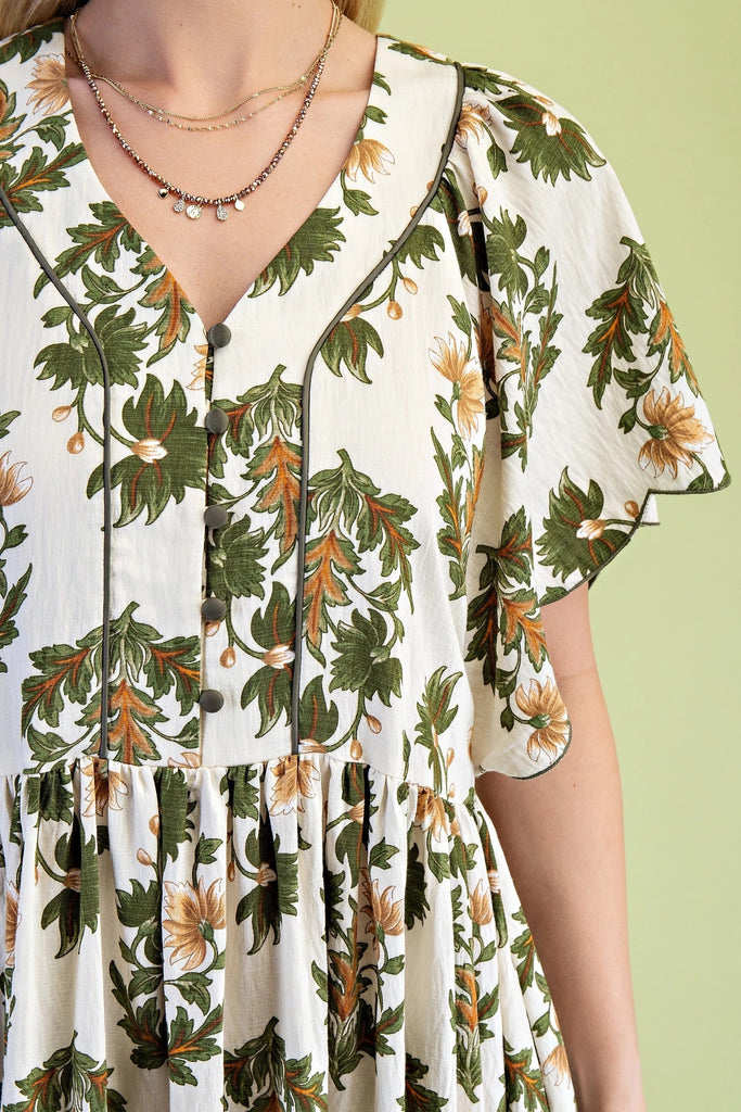 Midi dress with olive and golden floral print, V-neckline, scalloped short sleeves, covered buttons, and flowing skirt with border trim