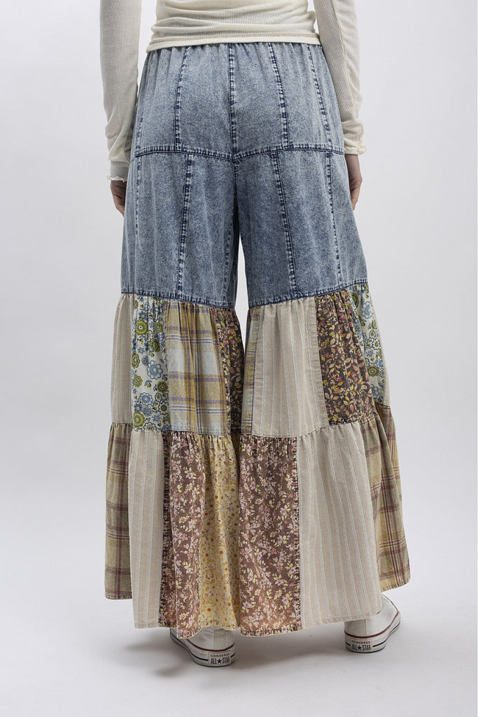 Patchwork wide-leg denim pants with floral, plaid, and striped fabric panels in earthy tones, boho boutique style